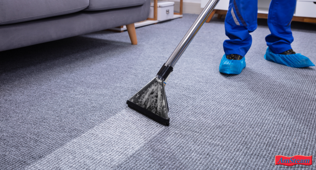 A person steam cleaning a carpet.